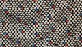 Dress fabric with all-over pattern of tiny flower motif mostly in white with one red and one blue in a diagonal line