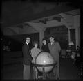 Members of the OSU G.E. College Bowl team posing in the Memorial Union with an oversized globe