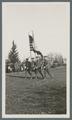 Cadet color guard marching on parade field, circa 1920