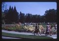 Students walking the Memorial Union Quad with flowers in full bloom, Oregon State University, Corvallis, Oregon, 1966