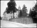 Buildings of St. Mary's Academy, with stone wall surrounding buildings in foreground.