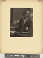 African-American man in suit, with book (recto)