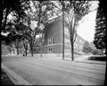 Couch School, Portland, with trees along 17th St. in foreground.