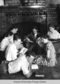 Students, Berea College, reading around the fireplace