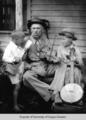 Unidentified man #1 with fiddle, unidentified boy # 1 with banjo, unidentified boy #2 with ukelele.