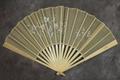 Folding fan of ivory carved in filigree designs and circles