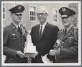 ROTC cadet officers presenting trophy to August L. Strand, 1960