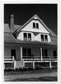 Assistant keepers house before 1980�s restoration. Person sitting on porch