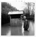 Man standing in front of flooded restroom