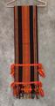 Loin Cloth of hand-woven black, orange, and yellow cotton in a varying striped pattern with yellow pinstripes
