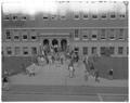 Student class change in front of Commerce Hall (Bexell Hall), November 1960