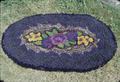 Hooked rug 32 x 22 inch oval (made by Ellen O'Connor in the 1940s from old material and wool mixed)