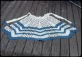 Crocheted apron, blue and white, 20 inch long x 12 inch wide at top, 21 at bottom, by Juanita Dias, Yorktown Texas 1921