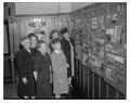 Members of an alumni reunion committee look at historic photographs.