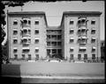 Highland Court Apartments, Glisan St., Portland, with potted plants on balconies and in entryways.