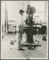 Student working with food processing equipment, Food Industries Lab, circa 1930