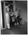 Phil Shadoin, 4-H counselor, with three boys, June 1955