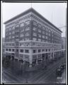 Morgan (?) building, Broadway and Park, Portland. Aaronson's Jewelers on corner, autos on street.