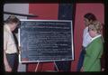 Meeting participants examining chalkboard notes, Oregon, 1975