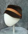Cloche style hat of brown piled felt with orange and pale orange ribbon trim and a ribbon-V of self brown fabric at back