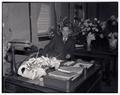 August L. Strand seated at desk, circa 1945