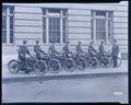 7 Portland policemen, on Harley-Davidson motorcycles. One officer standing next to them