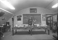 Speaker standing behind table in Native American Longhouse