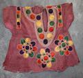 Child's blouse of faded red silk decorated in embroidery work without mirrors