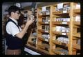 Honors Program student Roy Van Driesche examining insect specimens [?] in laboratory, Oregon State University, Corvallis, Oregon, circa 1969