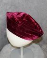 Cap of wine red silk velvet with a swirling center stripe in between two straight stripes