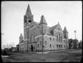 First Baptist Church, from intersection of 12th and Taylor. Unpaved streets in foreground, houses in background.