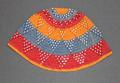 Cap of crocheted cotton in bands of red, blue and orange with open-work triangles