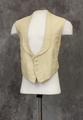 Vest of off-white diamond textured cotton with elongated rounded lapel cut-in-one with collar