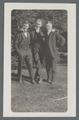 Three unidentified males posing together outdoors in formal dress, circa 1913