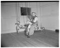 A child using a Hobby Horse swing at the Orchard Street Nursery School, May 1953