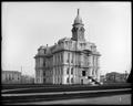 Full view of Marion County Courthouse, Salem, with clock tower. Street in foreground, Post Office in background.