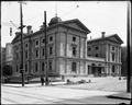 Post Office building under construction, 6th and Morrison, Portland. Construction debris on street in foreground.