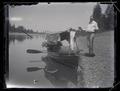 Herman Bohlman beside a boat with fruit