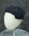 Hat of navy blue silk satin in a wrinkled design covered in net