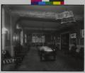 Interior of lounge, Elks Temple, Portland. Large table in center of room, chairs around edges. (recto)