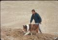 Lassie with handler in the dunes preparation for movie