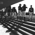 Baseball players standing in front of dugout