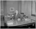 President Strand posing at his desk