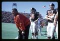 Football Coach Dee Andros with players on the sideline, Oregon State University, Corvallis, Oregon, circa 1971