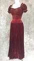 Evening dress of wine red velvet with smocked bodice and puffy short sleeves