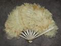 Folding fan of silver painted wood sticks with large white feathers adhered to paper