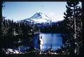 Backpacker posing with Mt. Hood and lake, Oregon, circa 1970