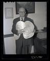 Godfrey V. Copson holding records documenting the grade and processing of milk