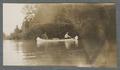 Three men canoeing on a river, circa 1910