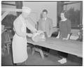 Al Oliver (slicing meat) and Bob Knoll, alumni manager, October 1949